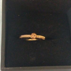 Pretty simple gold band little pink diamond in middle
